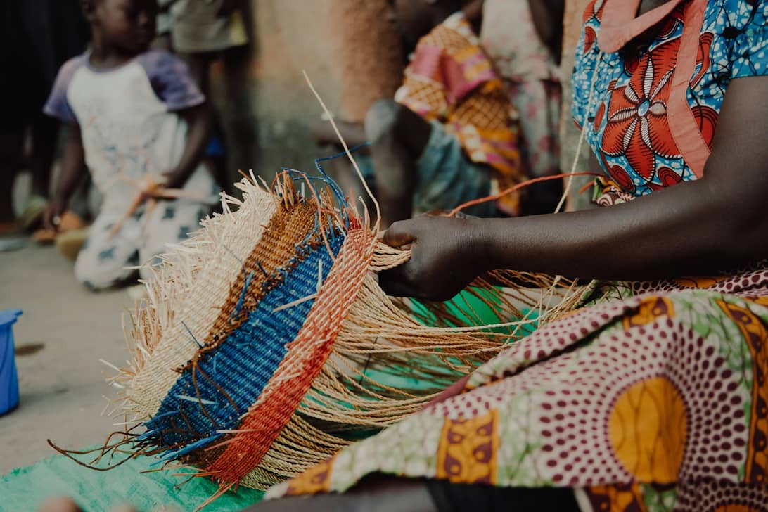  women sit and weave Frafra baskets
